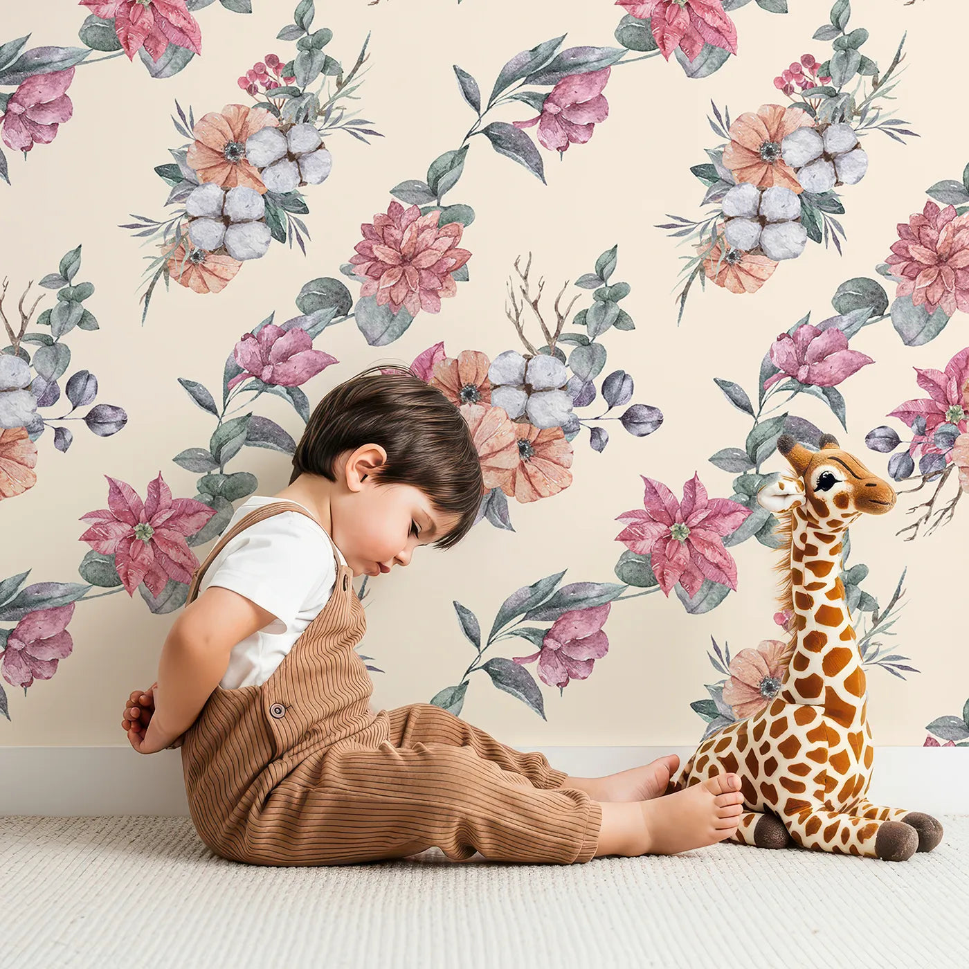 Lovely child standing in front of Whimsy Tots Winter Blooming Garden Wallpaper in Cream with flower, cotton, eucalyptus, poinsettia in design.
