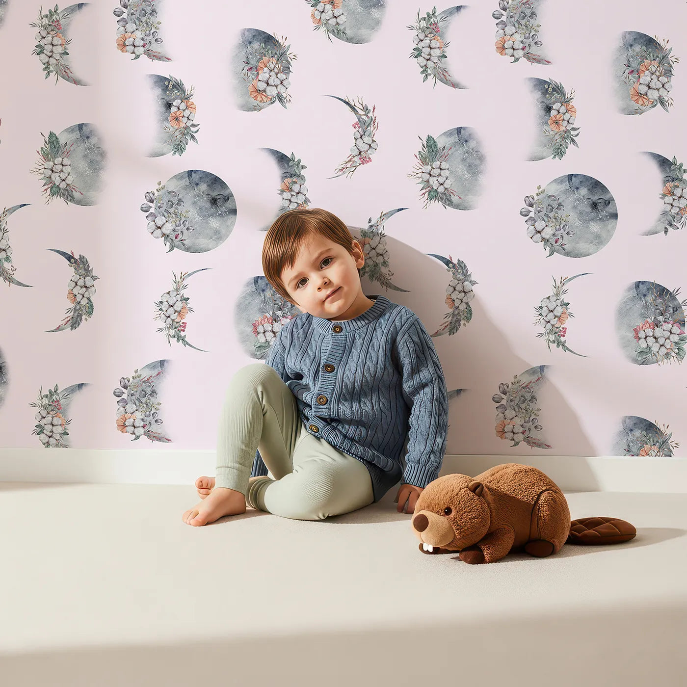 Lovely child standing in front of Whimsy Tots Celestial Winter Blooms Wallpaper in Blush Pink with moon, flower, cotton, eucalyptus in design.