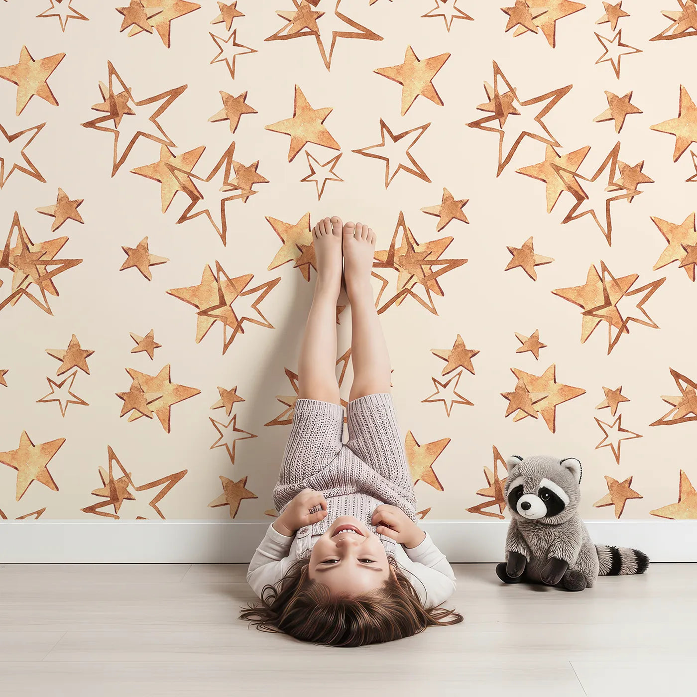 Lovely child standing in front of Whimsy Tots Golden Star Scatter Wallpaper in Cream with star in design.