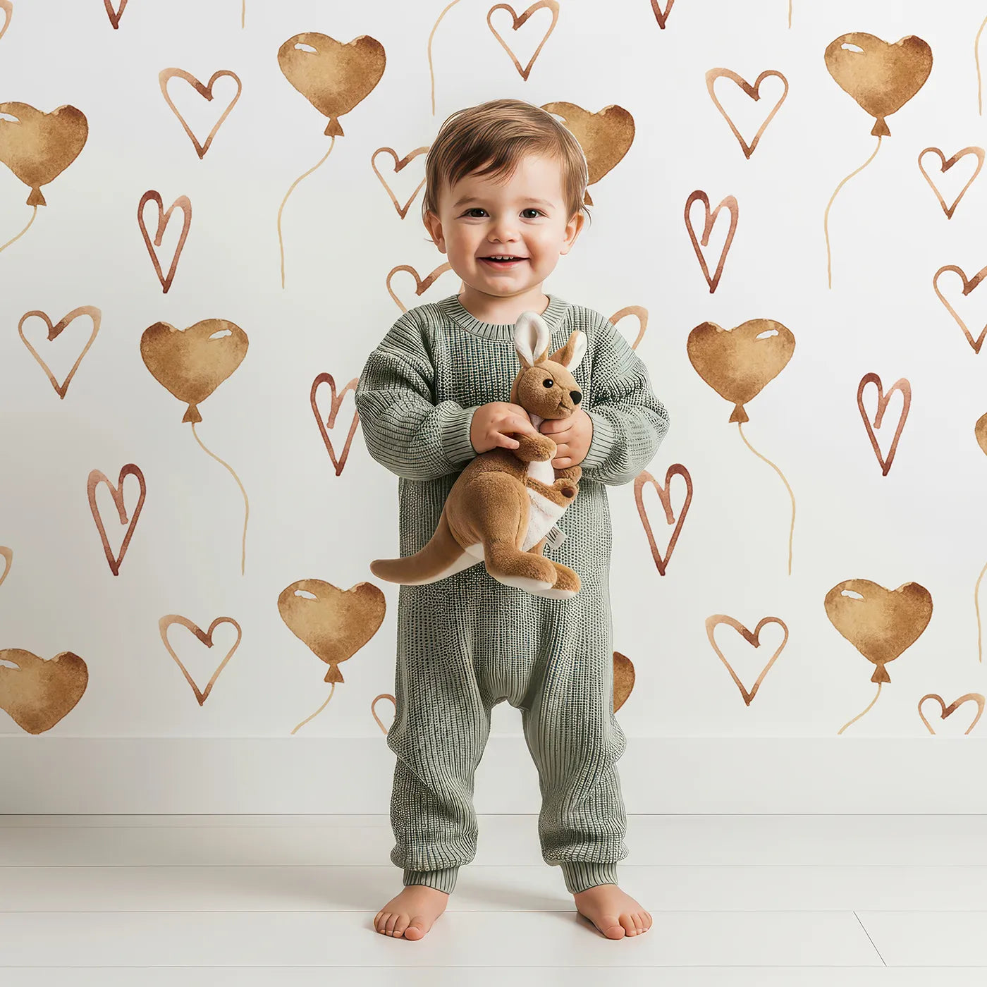 Lovely child standing in front of Whimsy Tots Heartfelt Balloons Wallpaper in White with heart, balloon, outline in design.