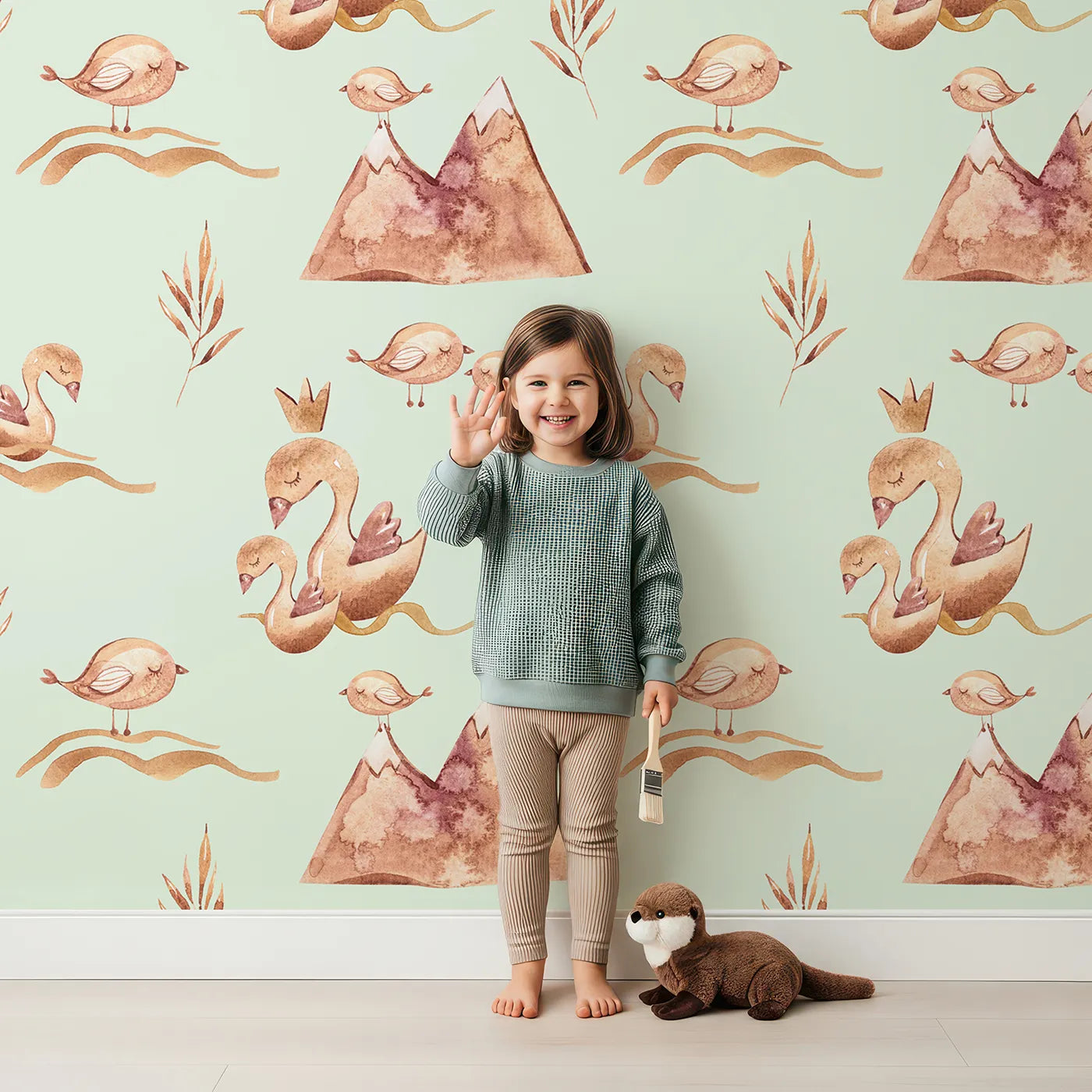 Lovely child standing in front of Whimsy Tots Feathered Serenity Wallpaper in Mint with bird, swan, crown, mountain, wing in design.