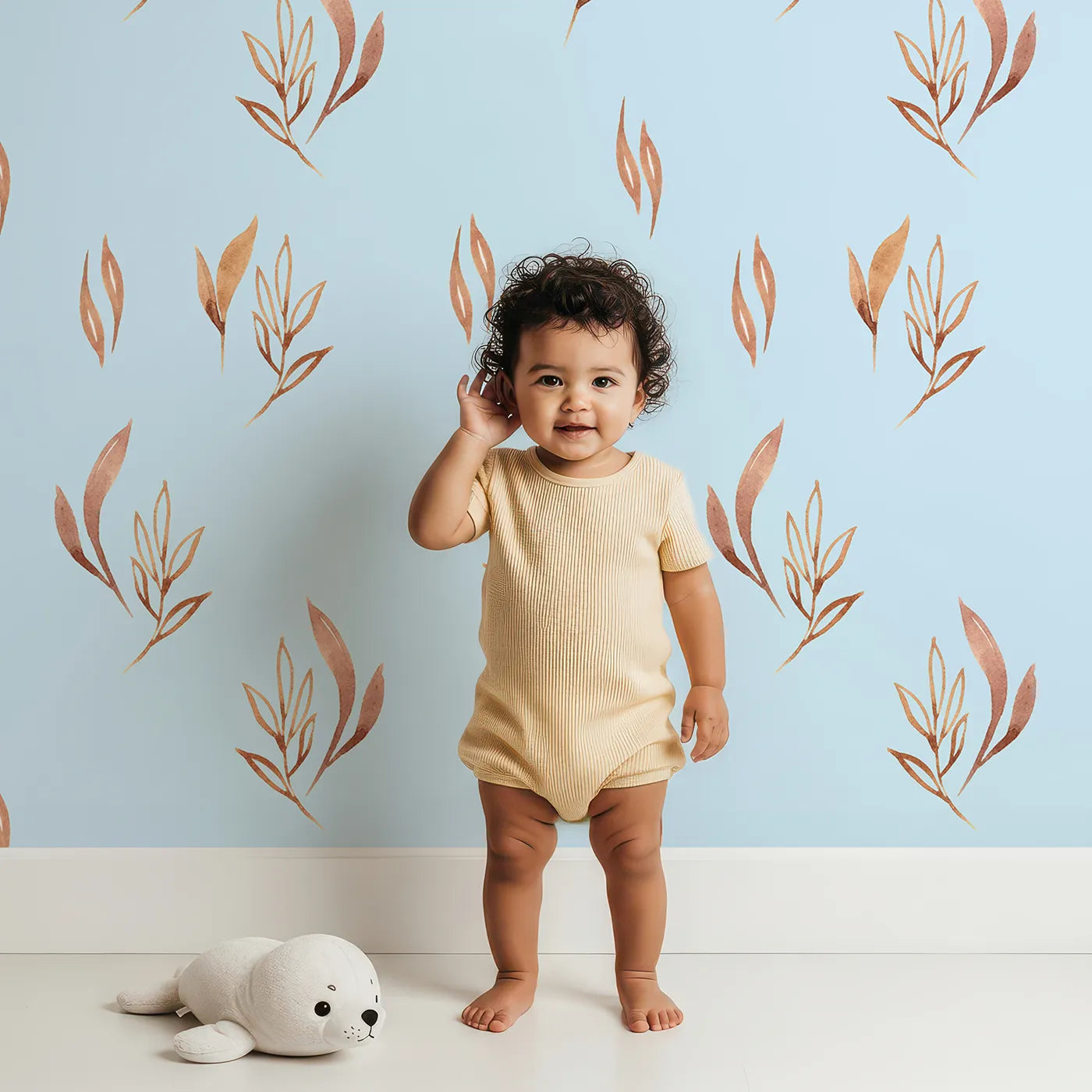 Lovely child standing in front of Whimsy Tots Rustling Meadow Sprigs Wallpaper in Sky with leaf, sprig, botanical, plant in design.