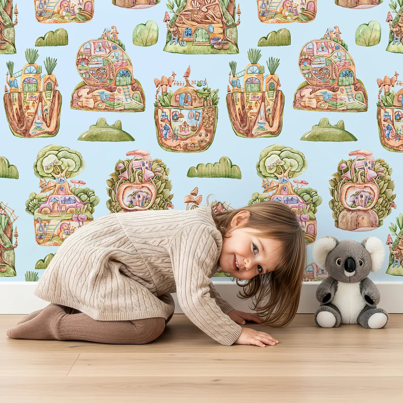 Lovely child standing in front of Whimsy Tots Secret Garden Cutaway Homes Wallpaper in Sky Blue with house, mushroom, vegetable, root, tree in design.