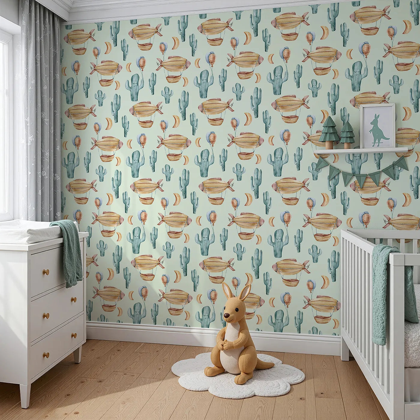 Angled view of Whimsy Tots' Cactus Cloud Voyage Wallpaper in Sage Green (W3391D).Soothing sage skies carry balloons, airships, and sleepy cacti across the desert breeze.