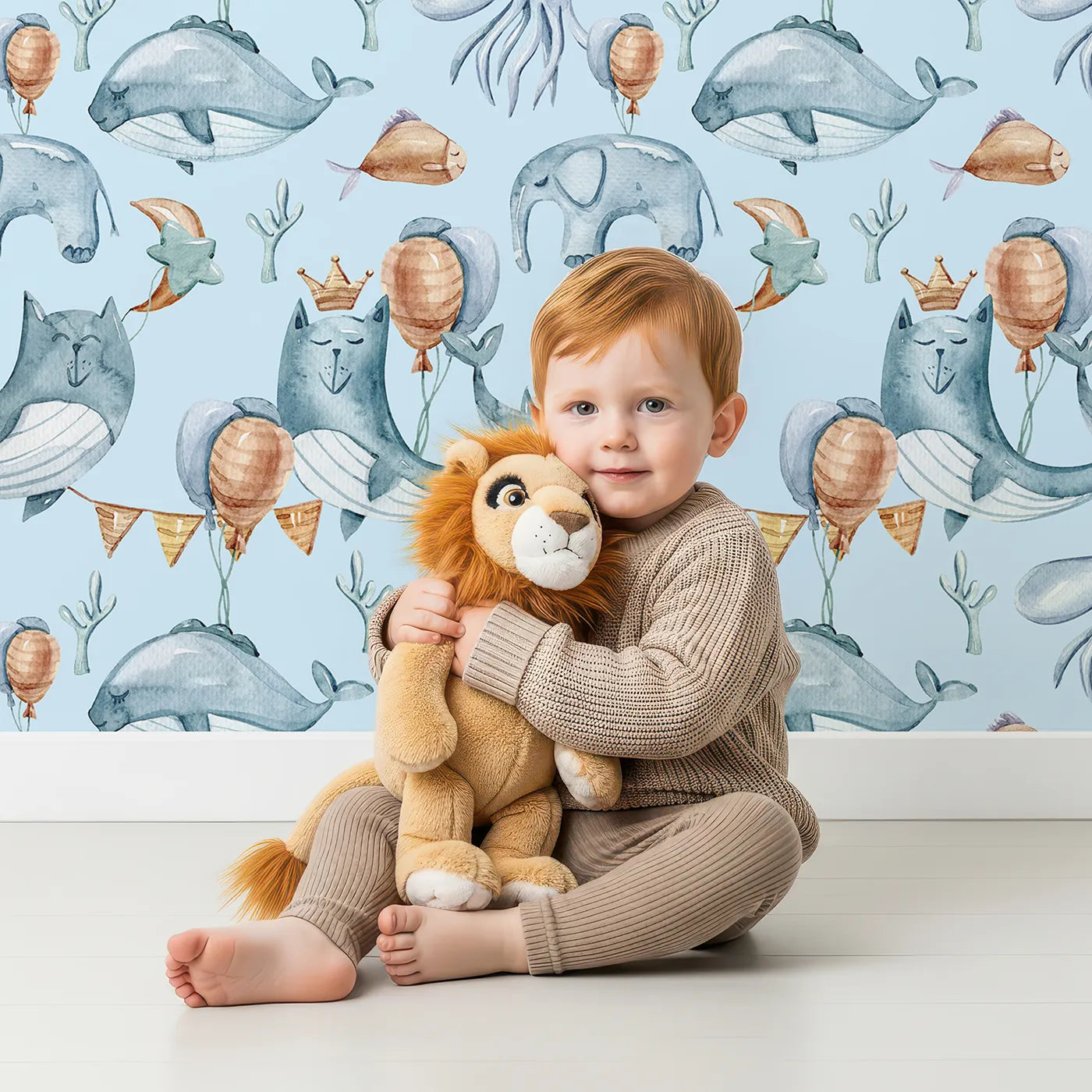 Lovely child standing in front of Whimsy Tots Ocean Pals Celebration Wallpaper in Sky with whale, balloon, octopus, coral, bunting in design.
