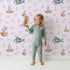 Lovely child standing in front of Whimsy Tots Seaside Vessel Parade Wallpaper in Pink with boat, submarine, splash, sail in design. Lovely child standing in front of Whimsy Tots Seaside Vessel Parade Wallpaper in Pink with boat, submarine, splash, sail in design.