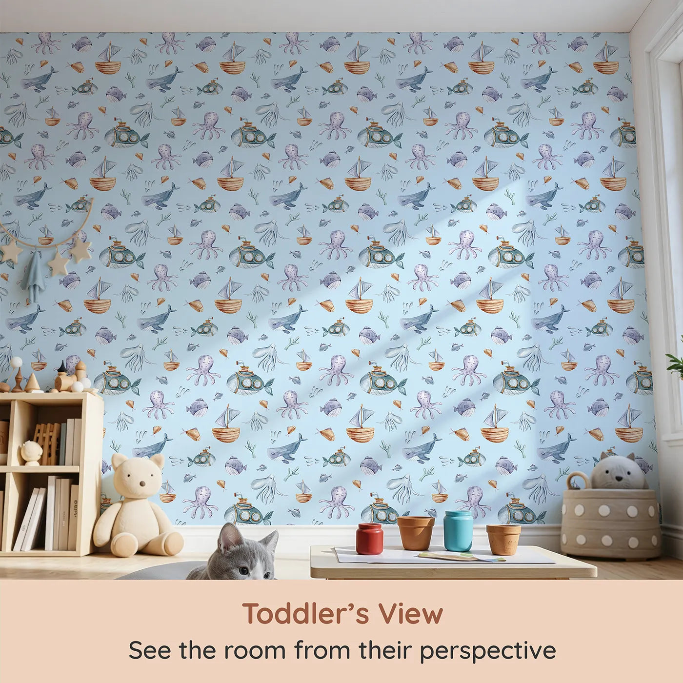 Whimsy Tots Deep Sea Discovery Wallpaper in Blue (W3403E) from your child's view.Playful whales and curious subs explore a peaceful ocean-blue sky.