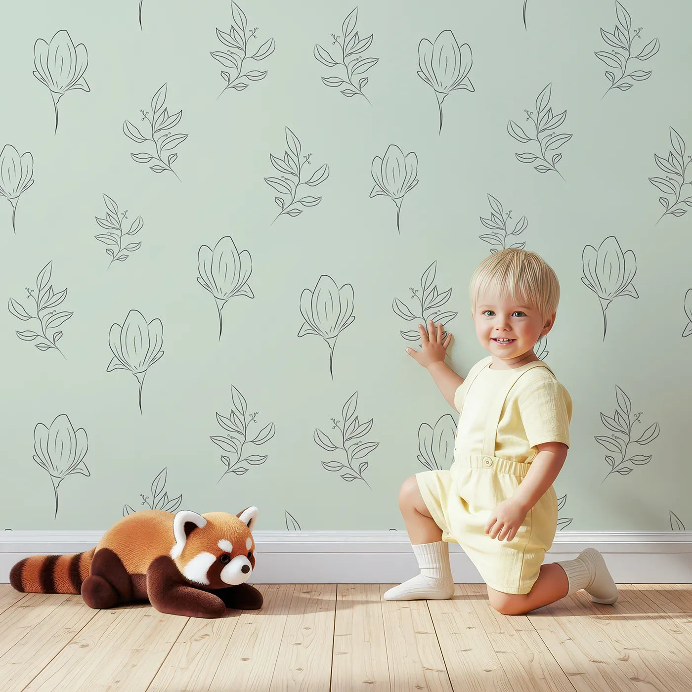 Lovely child standing in front of Whimsy Tots Petal Outline Grace Wallpaper in Mint Green with flower, leaf, sprig, botanical in design.