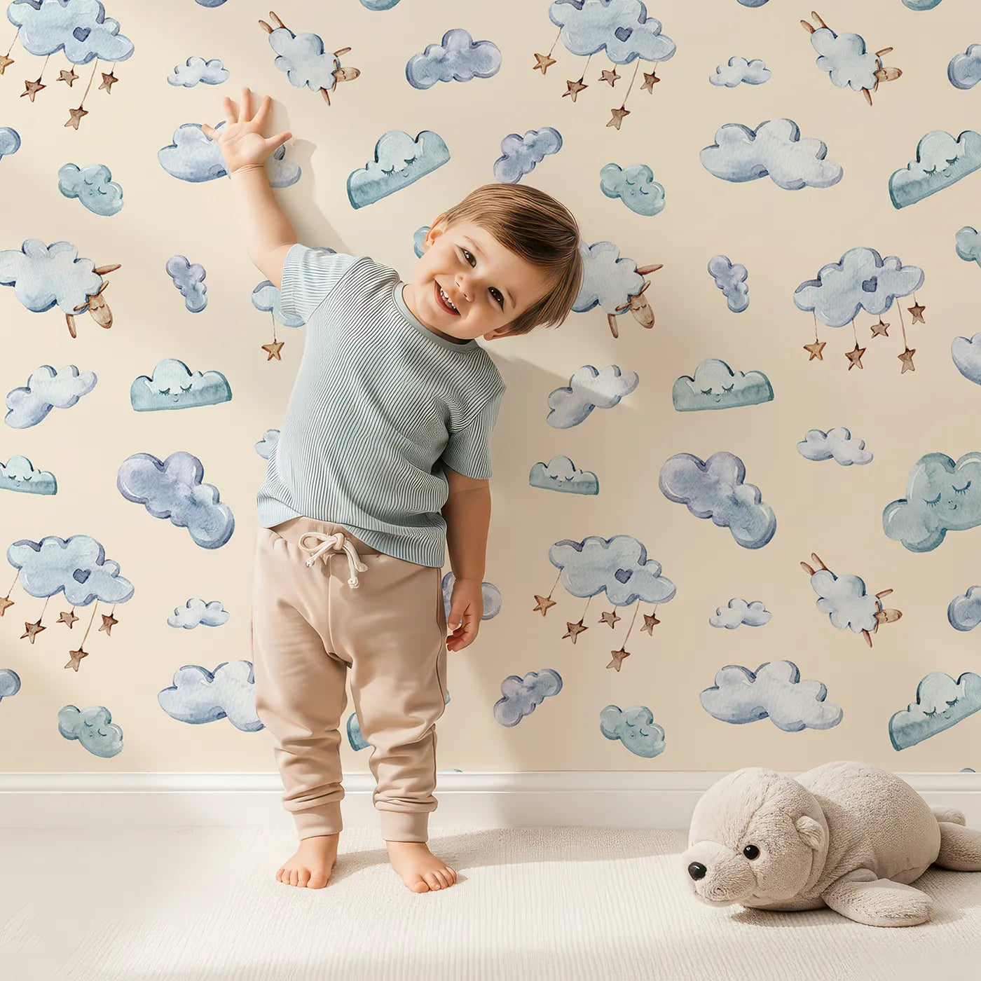 Lovely child standing in front of Whimsy Tots Cloudy Dreams Parade Wallpaper in Sand with cloud, star, sheep, sky in design.