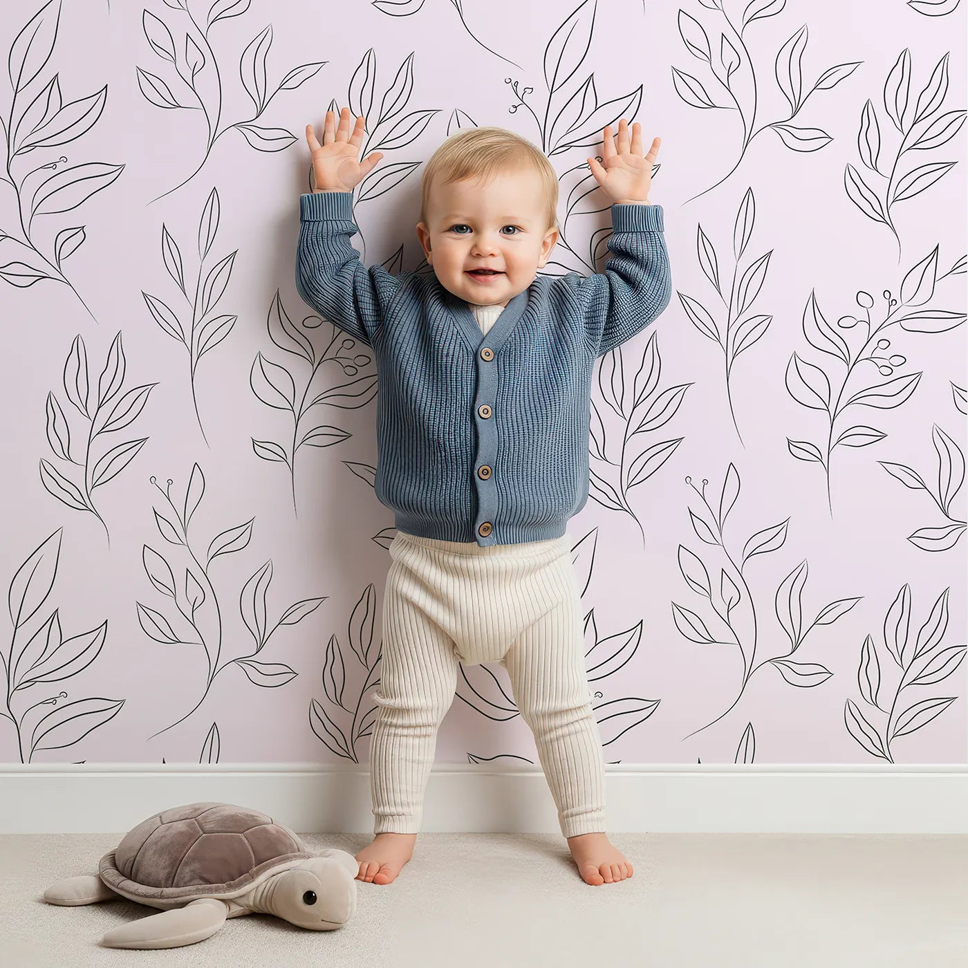 Lovely child standing in front of Whimsy Tots Wild Leafline Garden Wallpaper in Blush Pink with leaf, botanical, sprig, berry, line art in design.
