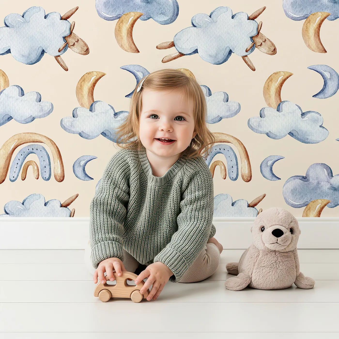 Lovely child standing in front of Whimsy Tots Sleepy Cloud Parade Wallpaper in Sand with cloud, moon, sheep, rainbow, star in design.