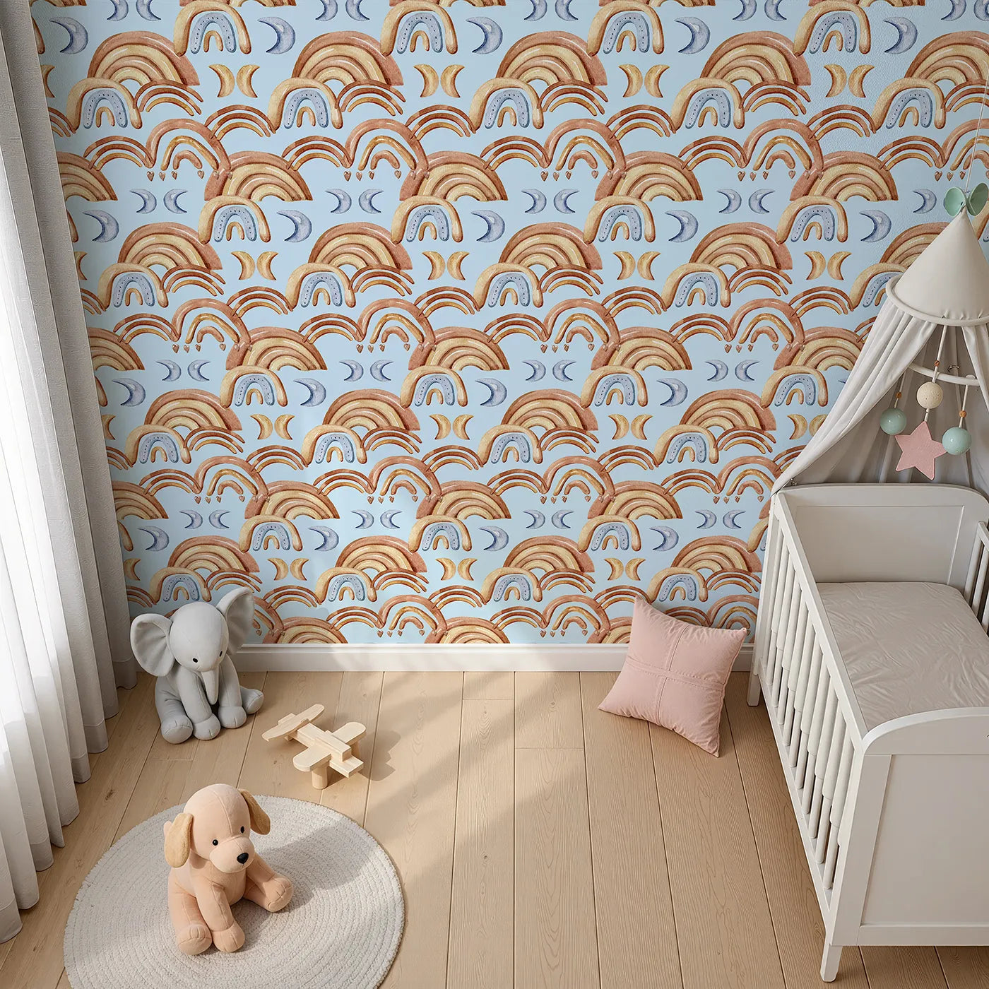 Top-Down view of Whimsy Tots' Boho Rainbow Night Wallpaper in Blue (W3423E).Warm arches and cool moons drift across a soft blue sky.