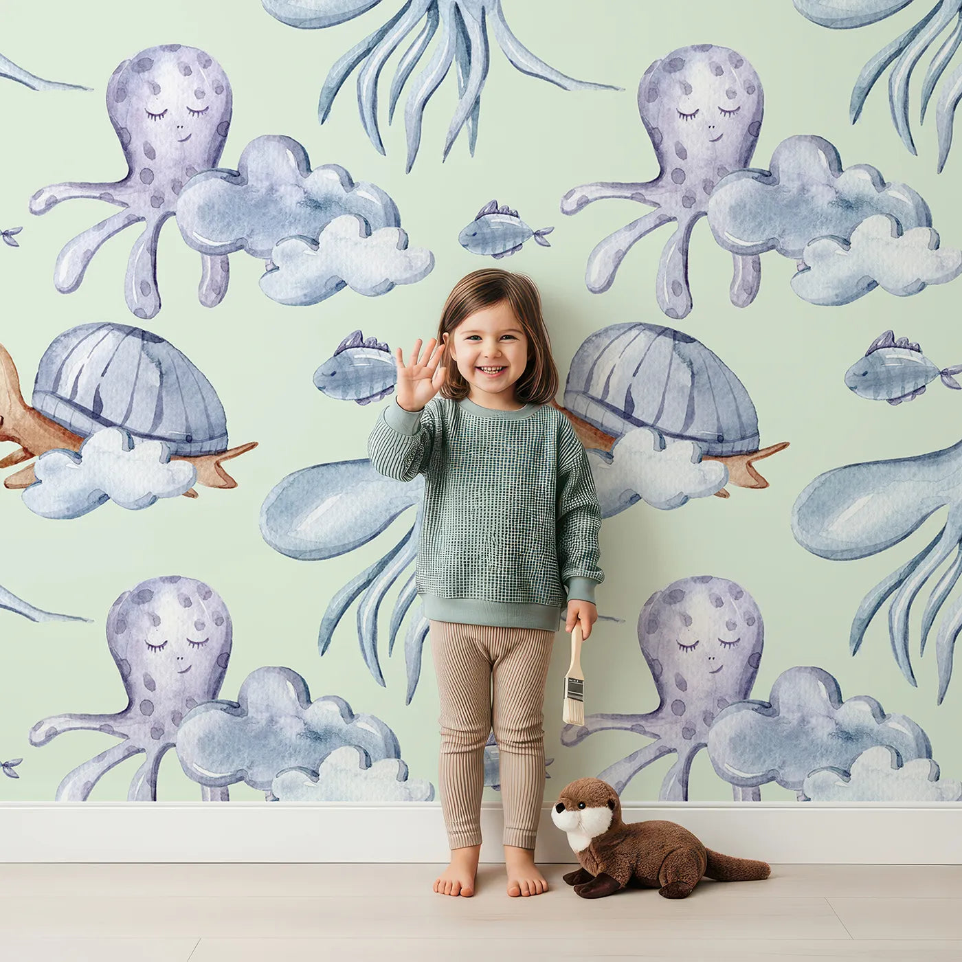 Lovely child standing in front of Whimsy Tots Ocean Cloud Cuddle Wallpaper in Mint Green with turtle, octopus, fish, cloud, squid in design.
