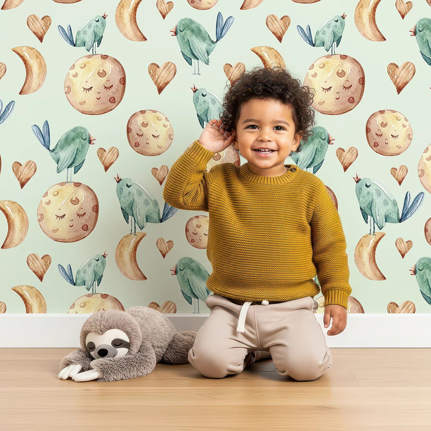 Lovely child standing in front of Whimsy Tots Lunar Lullaby Birds Wallpaper in Mint Green with bird, moon, heart in design.