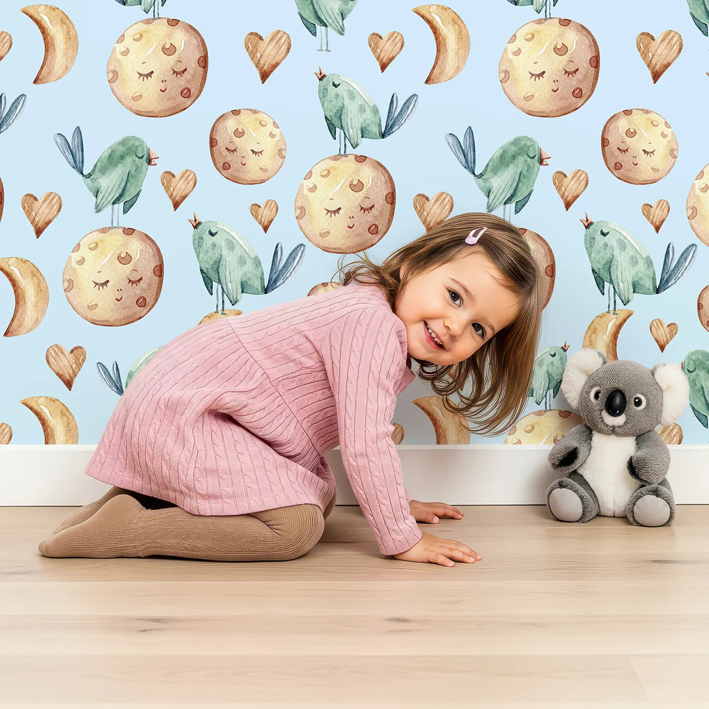 Lovely child standing in front of Whimsy Tots Lunar Lullaby Birds Wallpaper in Sky Blue with bird, moon, heart in design.
