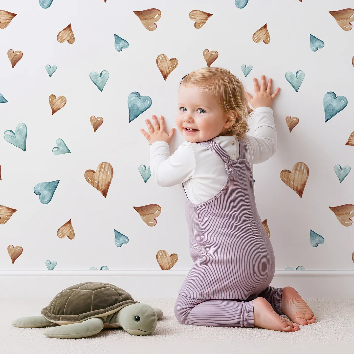 Lovely child standing in front of Whimsy Tots Heartful Whimsy Wallpaper in White with heart in design.