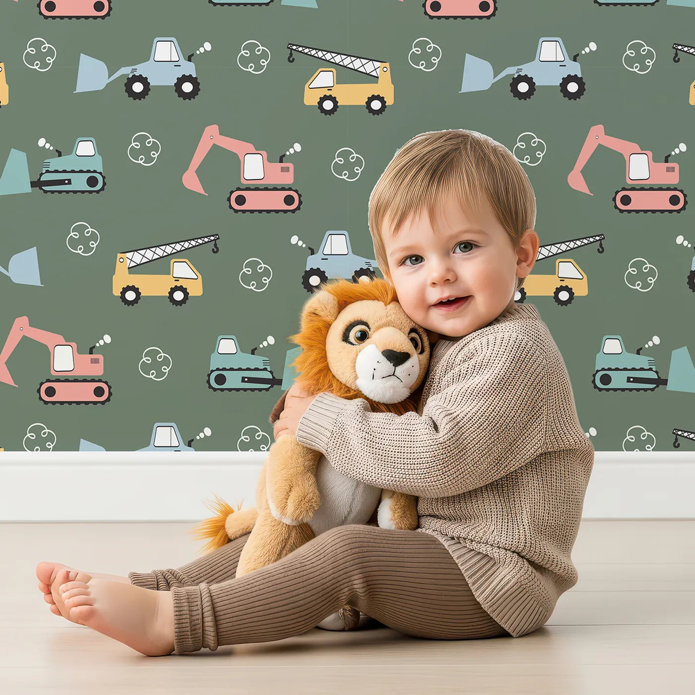 Lovely child standing in front of Whimsy Tots Mighty Machines Construction Wallpaper in Olive Green with truck, crane, bulldozer, excavator, vehicle in design.