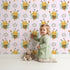 Lovely child standing in front of Whimsy Tots Bee Blossom Parade Wallpaper in Blush Pink with bee, flower, honey in design. Lovely child standing in front of Whimsy Tots Bee Blossom Parade Wallpaper in Blush Pink with bee, flower, honey in design.
