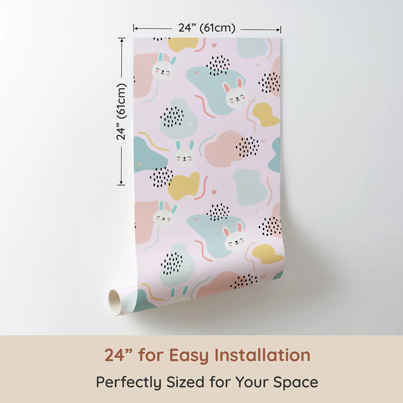 Dimension view of Whimsy Tots Bunny Bounce Abstract Wallpaper in Blush Pink (W3443A). Printed in 24-inch-wide panel for easy installation. Smiling rabbits and playful shapes hop across a dreamy pink sky.