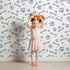 Lovely child standing in front of Whimsy Tots Puppy Paw Parade Wallpaper in Blue Gray with paw, bone, dot in design. Lovely child standing in front of Whimsy Tots Puppy Paw Parade Wallpaper in Blue Gray with paw, bone, dot in design.