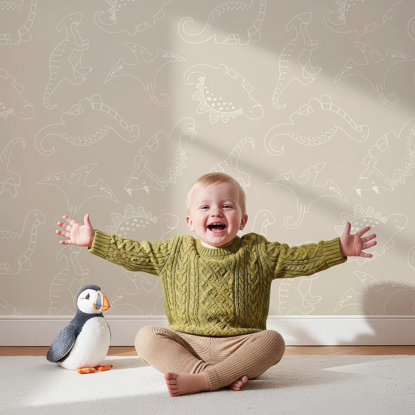 Lovely child standing in front of Whimsy Tots Dino Scribble Parade Wallpaper in Beige with dinosaur, stegosaurus, triceratops, pterosaur in design.