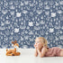 Lovely child standing in front of Whimsy Tots Coral Garden Dance Wallpaper in Deep Indigo with coral, seaweed, starfish, bubble in design. Lovely child standing in front of Whimsy Tots Coral Garden Dance Wallpaper in Deep Indigo with coral, seaweed, starfish, bubble in design.