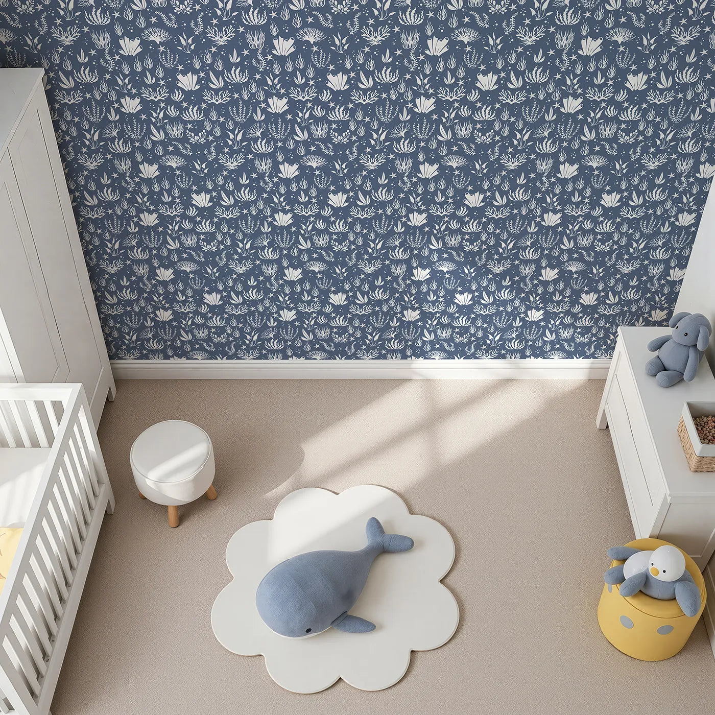 Top-Down view of Whimsy Tots' Coral Garden Dance Wallpaper in Deep Indigo (W3476E).Sea life silhouettes drift peacefully through a deep indigo sea.