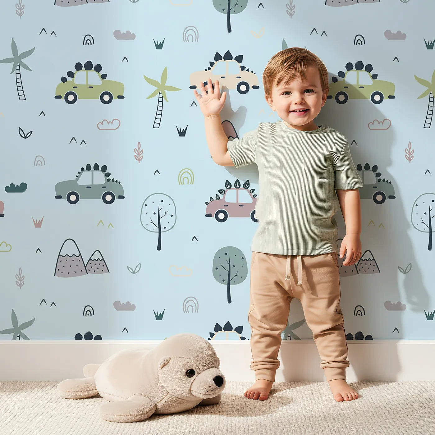 Lovely child standing in front of Whimsy Tots Dino Drivers Parade Wallpaper in Sky Blue with dinosaur, car, tree, rainbow, mountain in design.