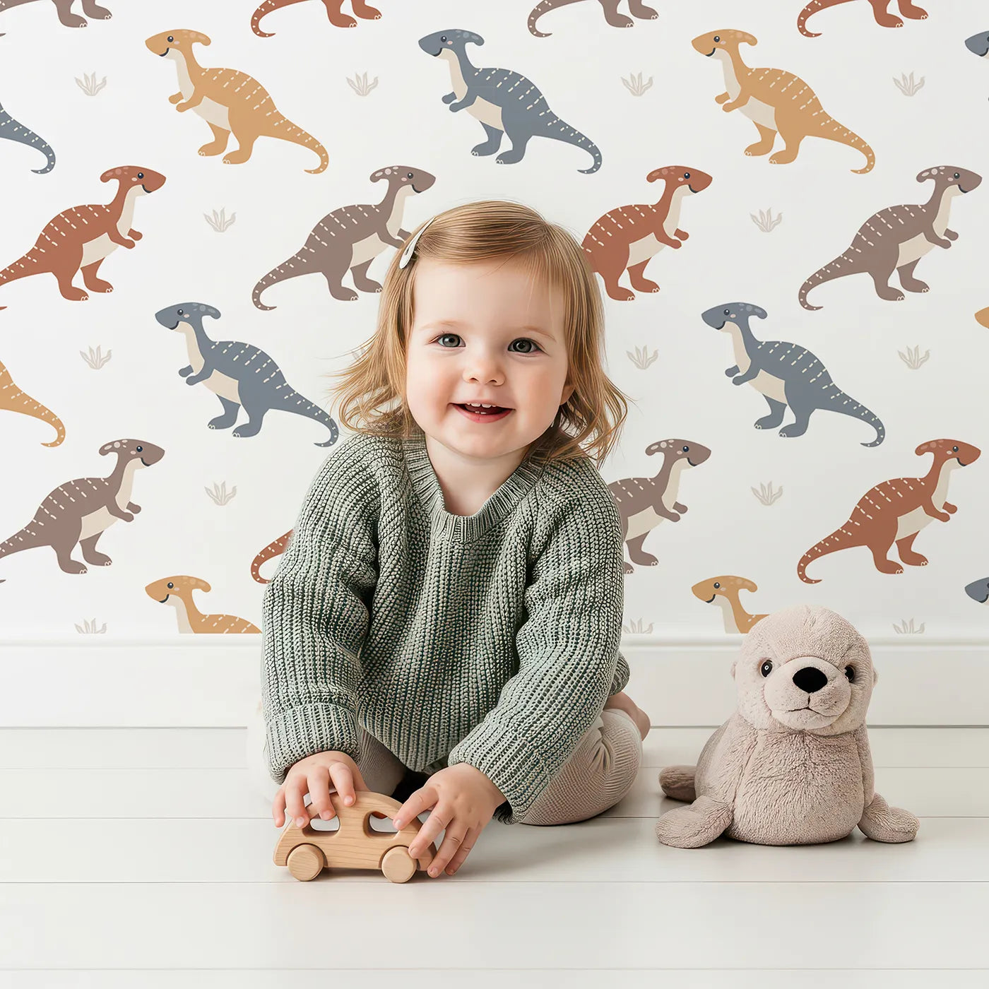 Lovely child standing in front of Whimsy Tots Gentle Dino Trek Wallpaper in White with dinosaur, footprint, plant in design.
