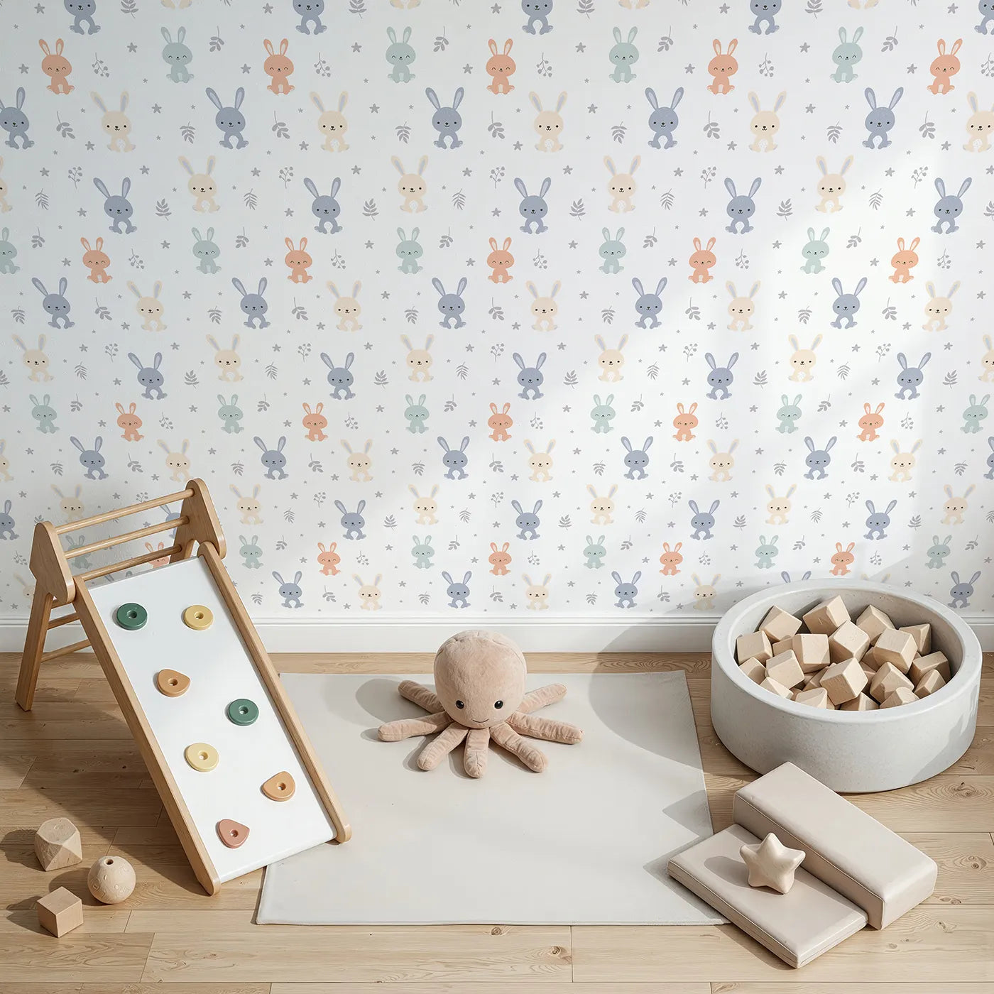Top-Down view of Whimsy Tots' Bunny Meadow Friends Wallpaper in Soft Neutrals (W3494).Happy bunnies sit among leaves, stars, and gentle smiles.