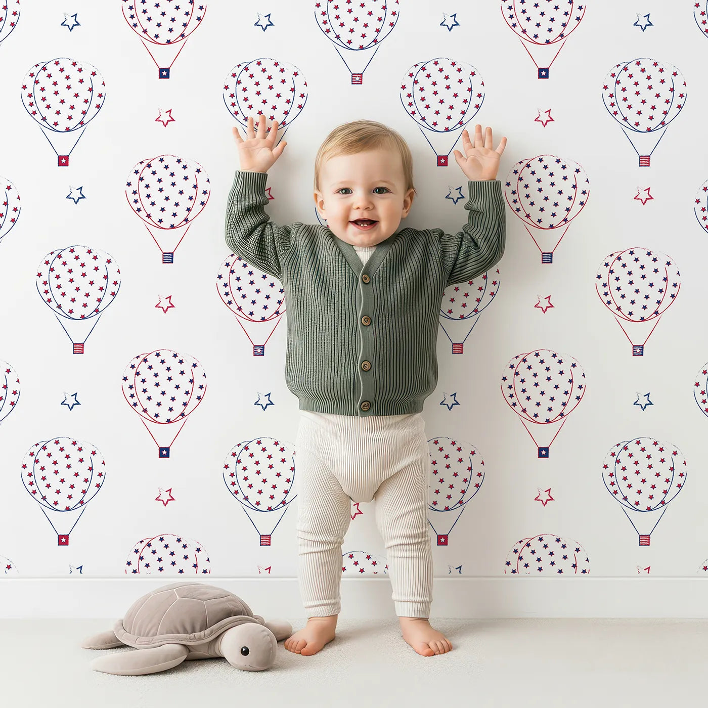 Lovely child standing in front of Whimsy Tots Starry Balloon Festival Wallpaper with balloon, star, stripe, patriotic, sky in design.