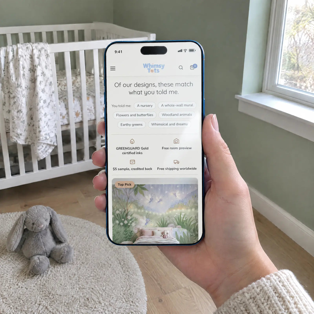 Phone showing Whimsy Tots nursery wallpaper quiz results, with the parent's answers and a Top Pick mural