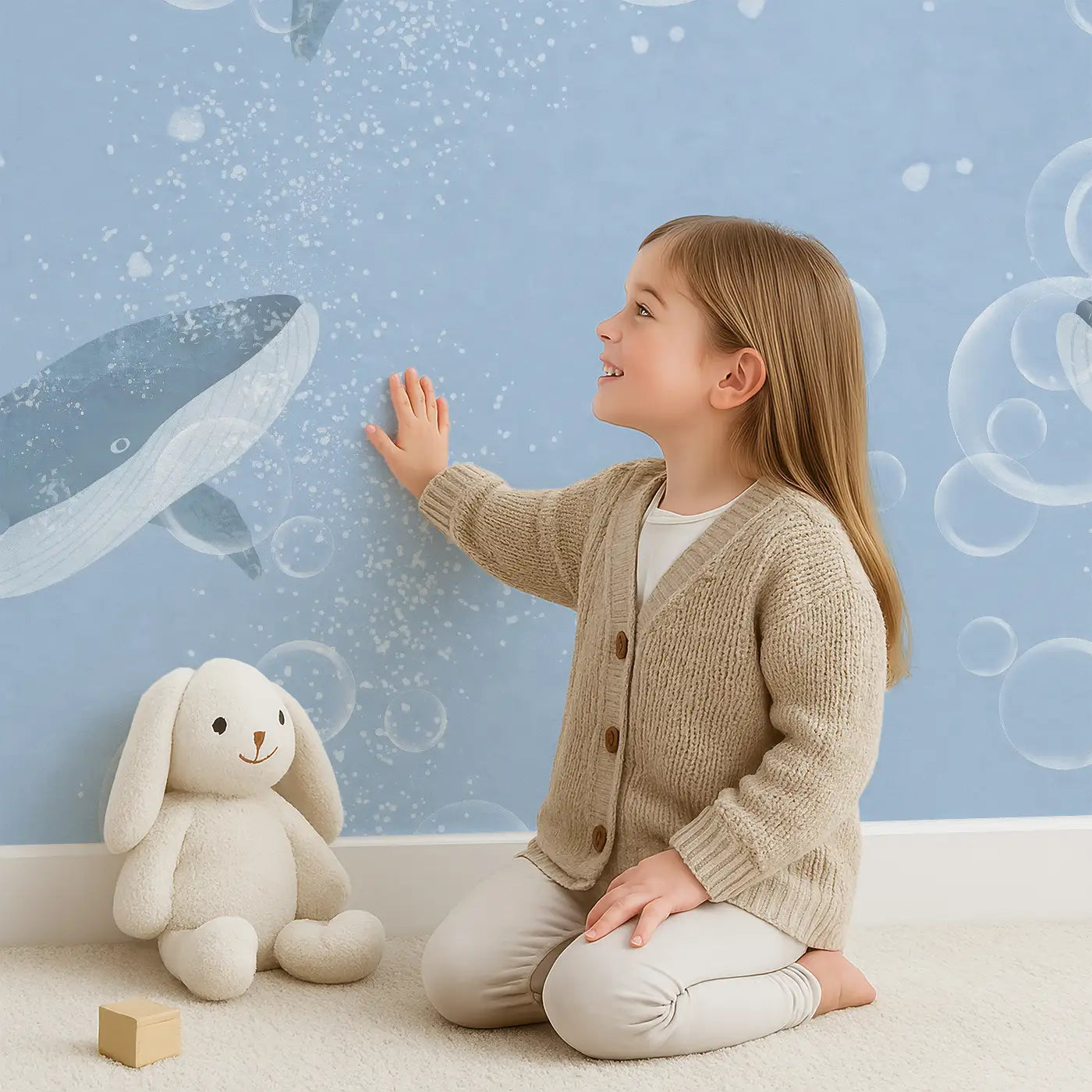 Child in front of Whimsy Tots Bubble Whale Wonderland Wall Mural with whale, bubble, ocean, water in design.