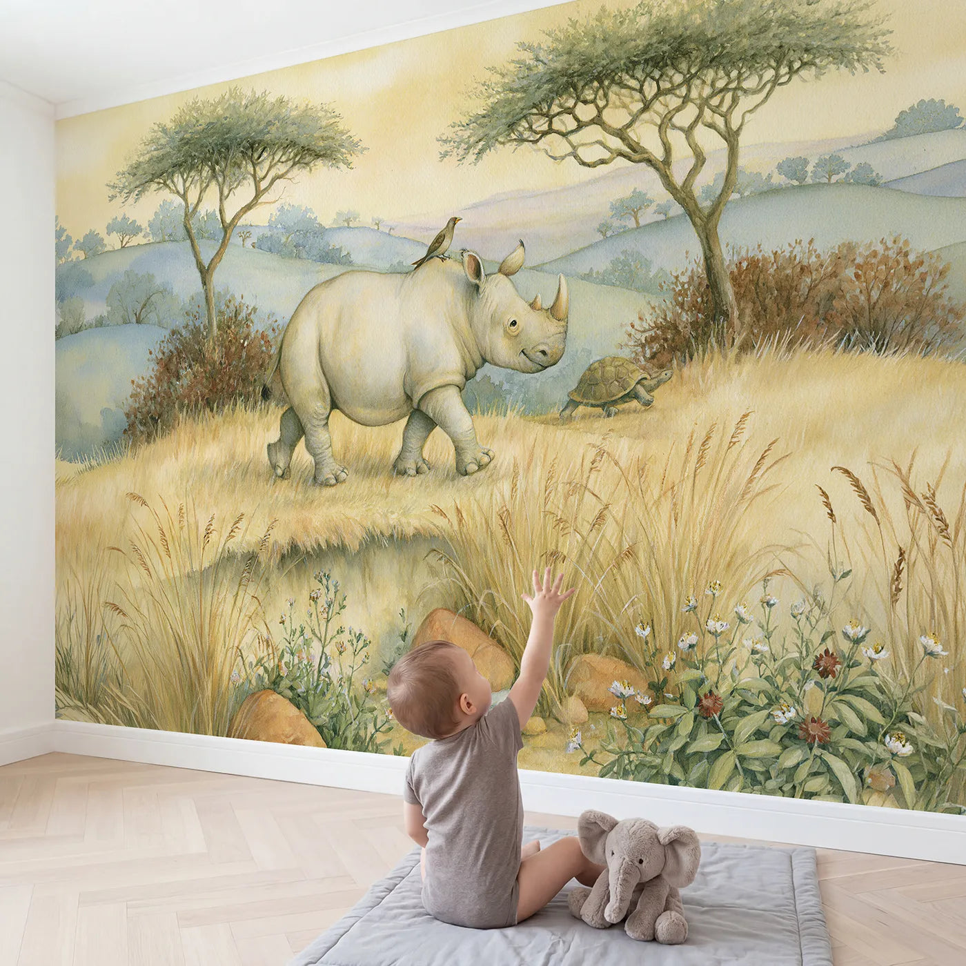 Child in nursery with Friendly Rhino Bird Wallpaper Mural by Whimsy Tots
