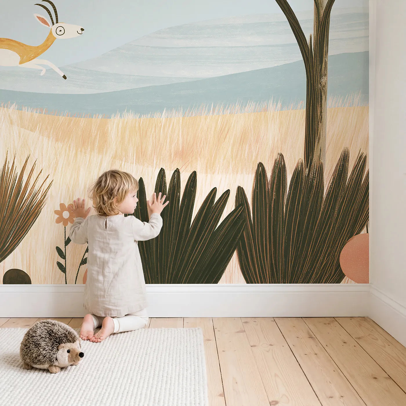 Child in nursery with Folk Gazelle Leap Wallpaper Mural by Whimsy Tots
