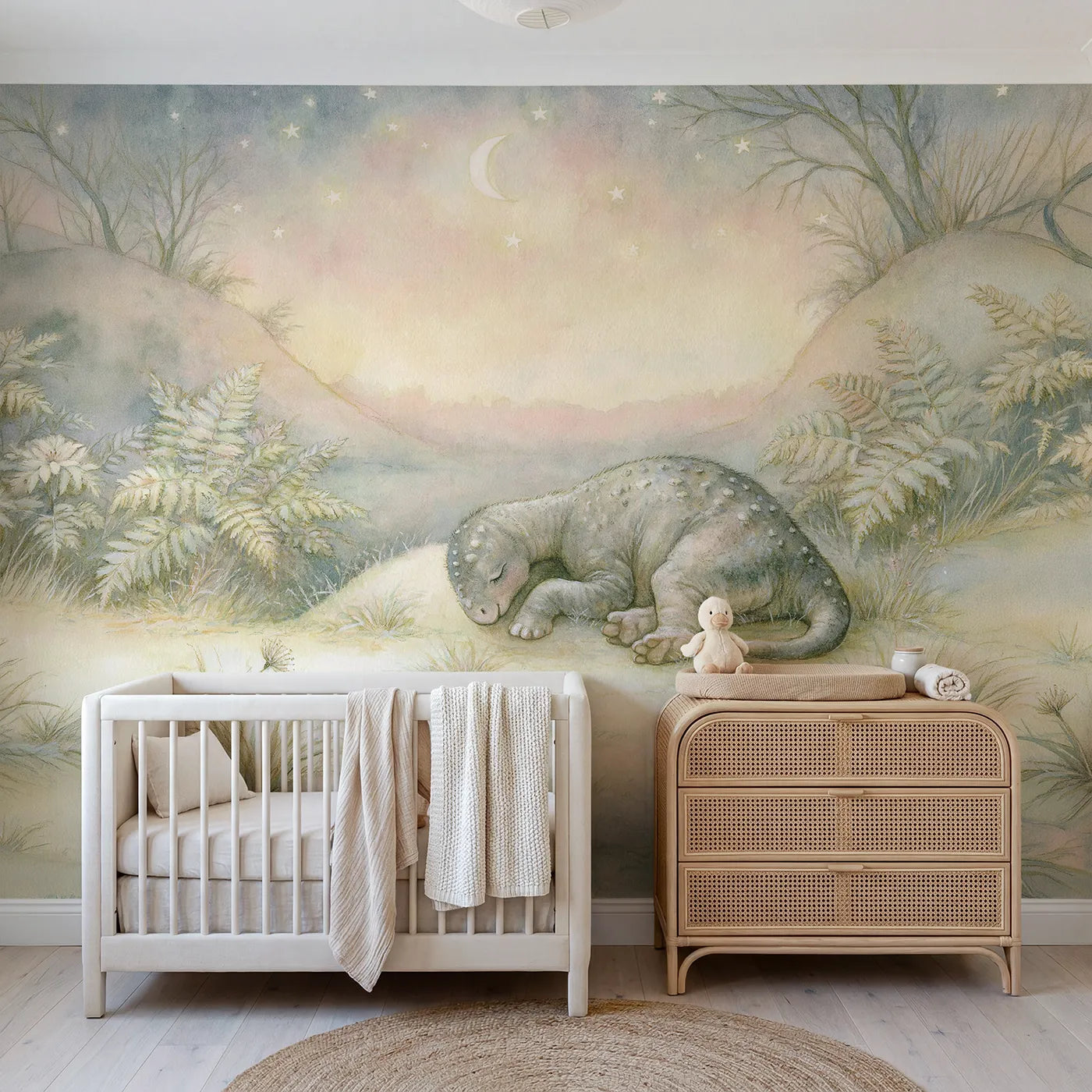 Storybook wall mural of a tiny dinosaur under stars by Whimsy Tots
