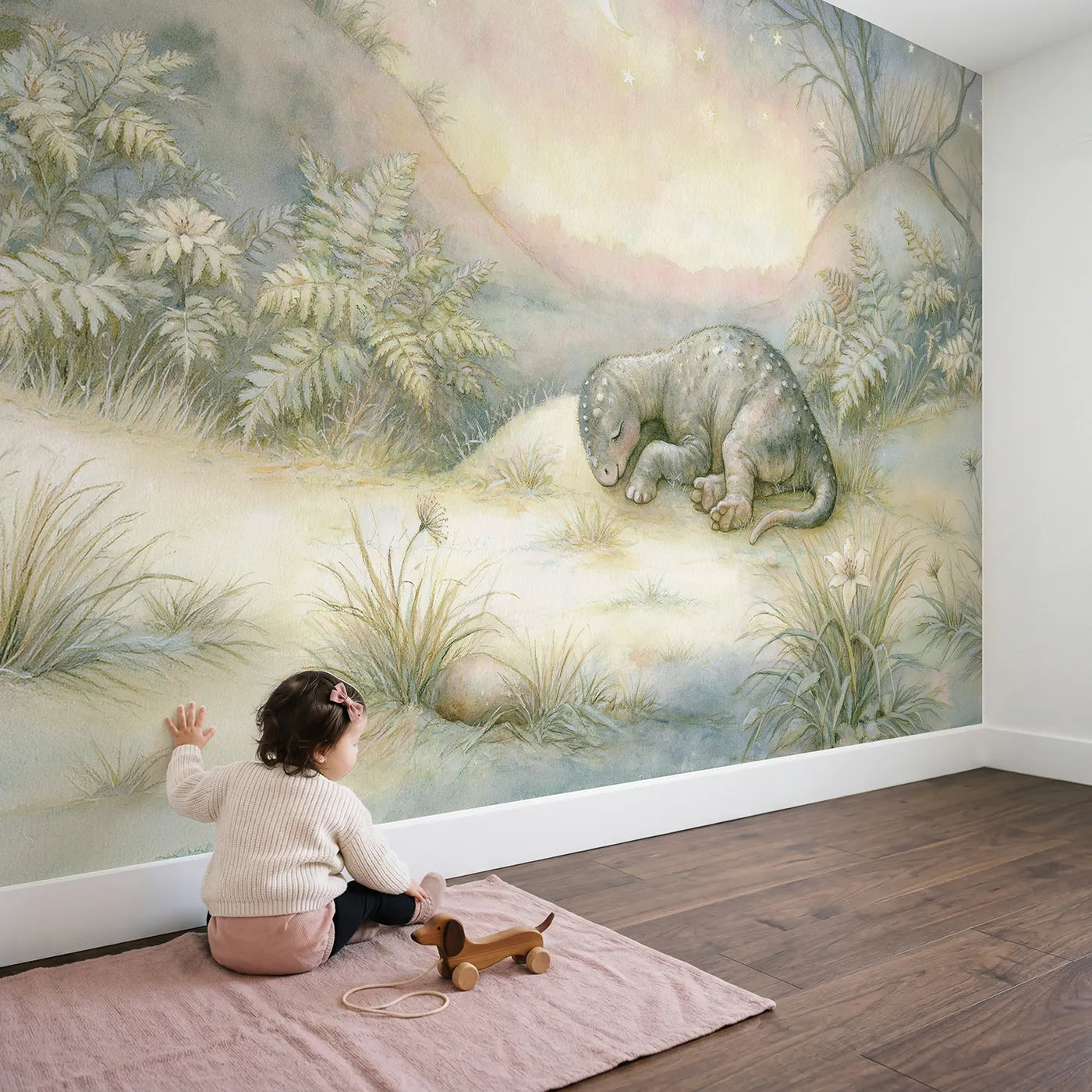 Child in nursery with Tiny Dino Dreams Wallpaper Mural by Whimsy Tots