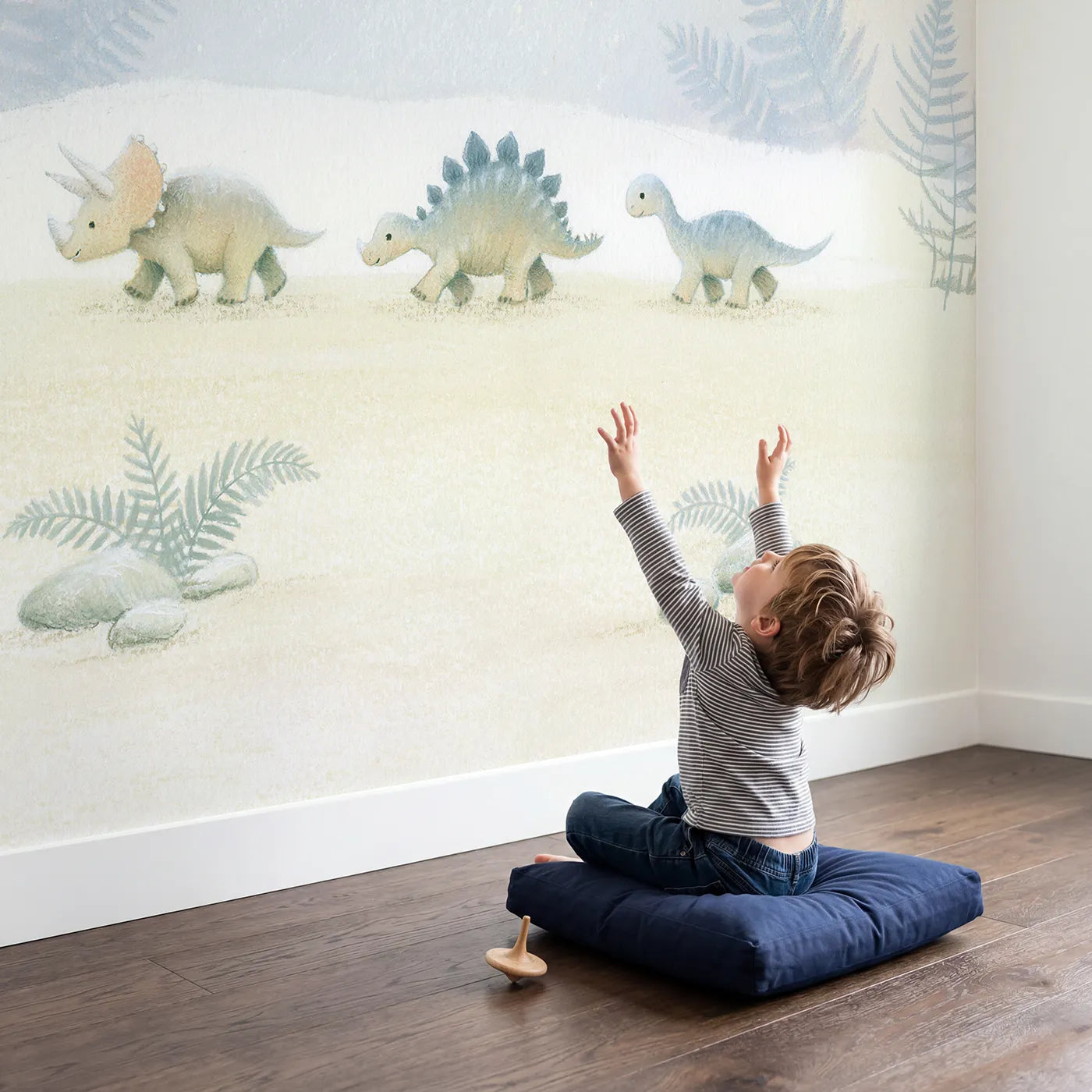 Child in nursery with Soft Dino Parade Wallpaper Mural by Whimsy Tots