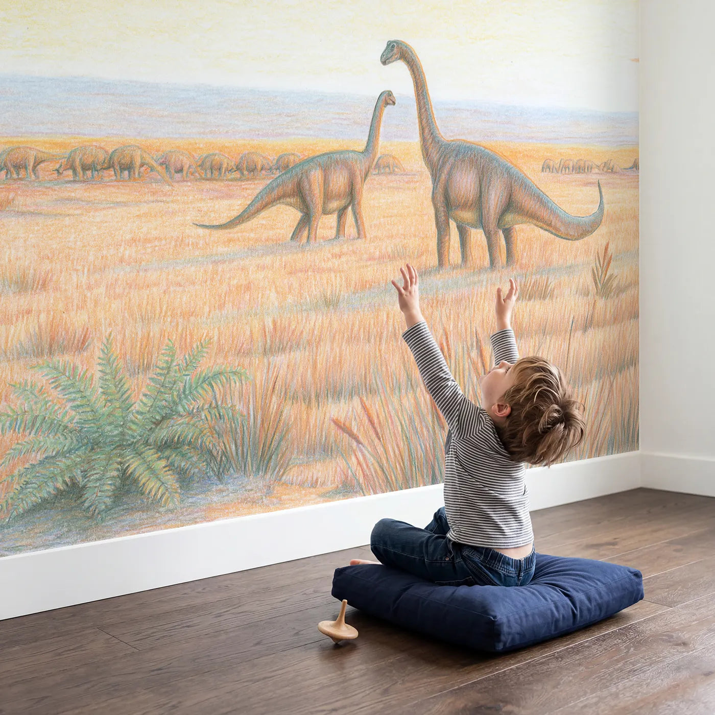 Child in nursery with Sauropod Herd Calm Wallpaper Mural by Whimsy Tots