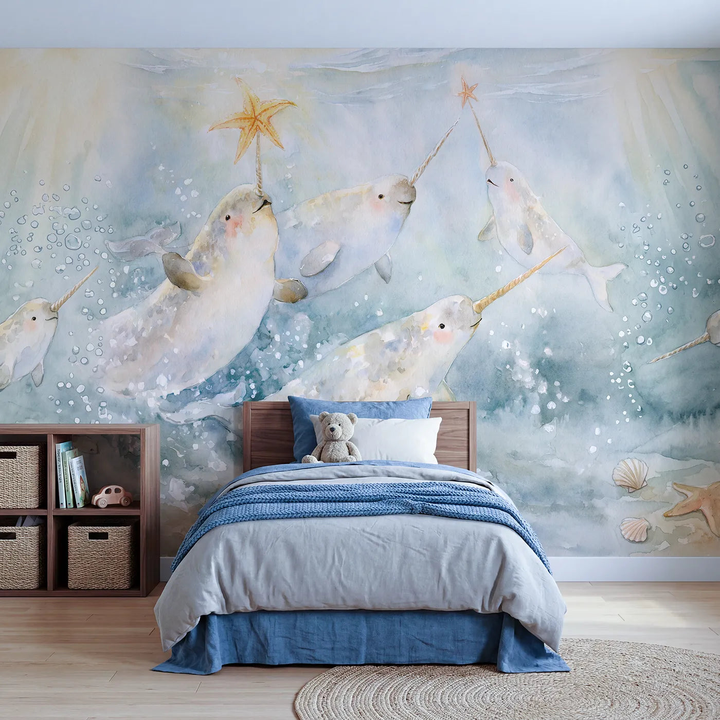 Watercolor narwhals passing a sea star on their tusks, wall mural for a playroom by Whimsy Tots