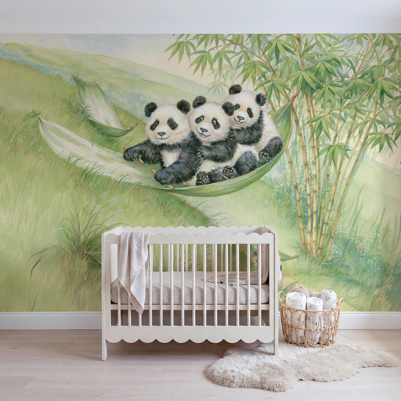 Storybook panda cubs sledding on a bamboo leaf, wall mural for a playroom by Whimsy Tots