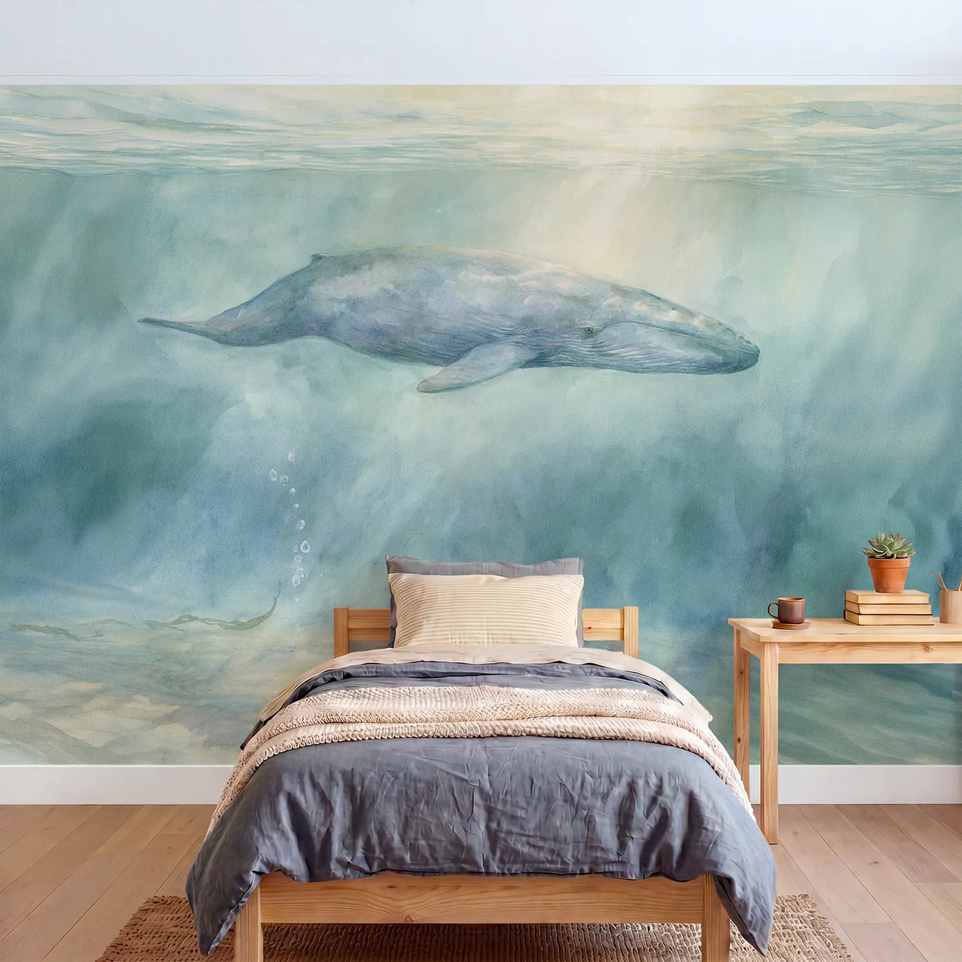 Watercolor wall mural of an immense calm blue whale by Whimsy Tots