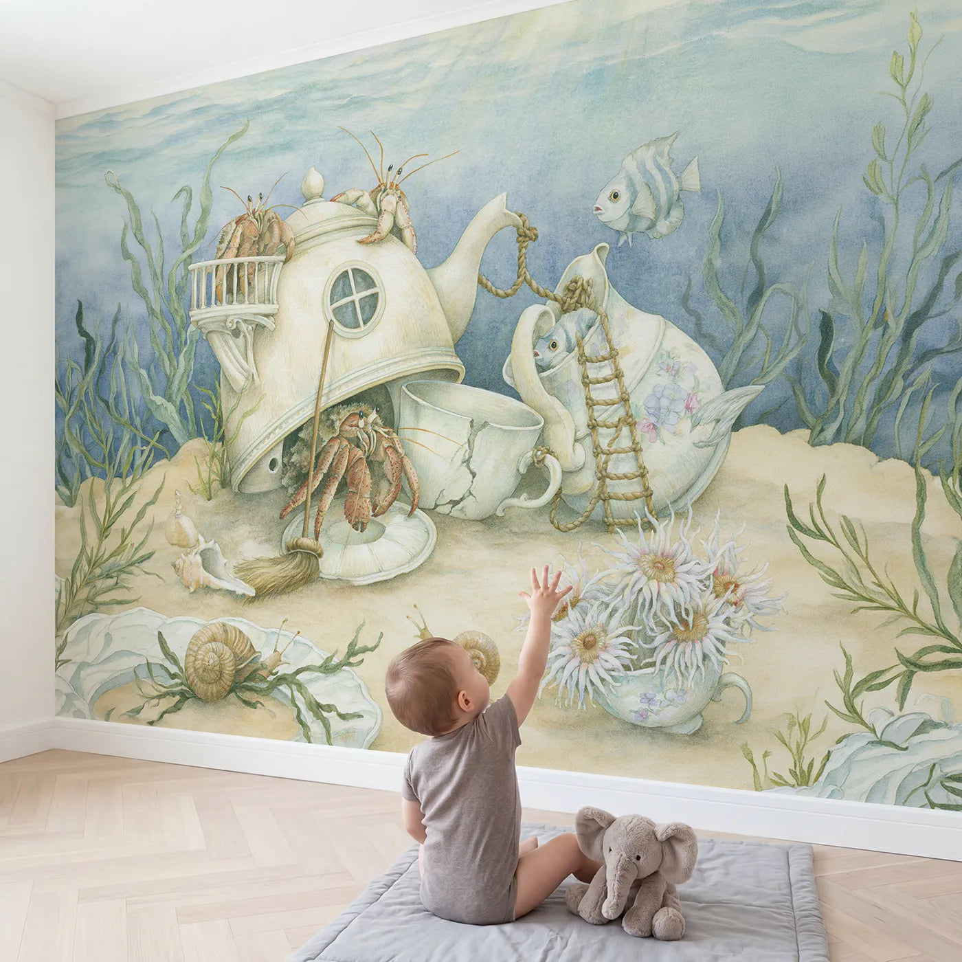 Child in nursery with The Sunken Teapot Town Wallpaper Mural by Whimsy Tots