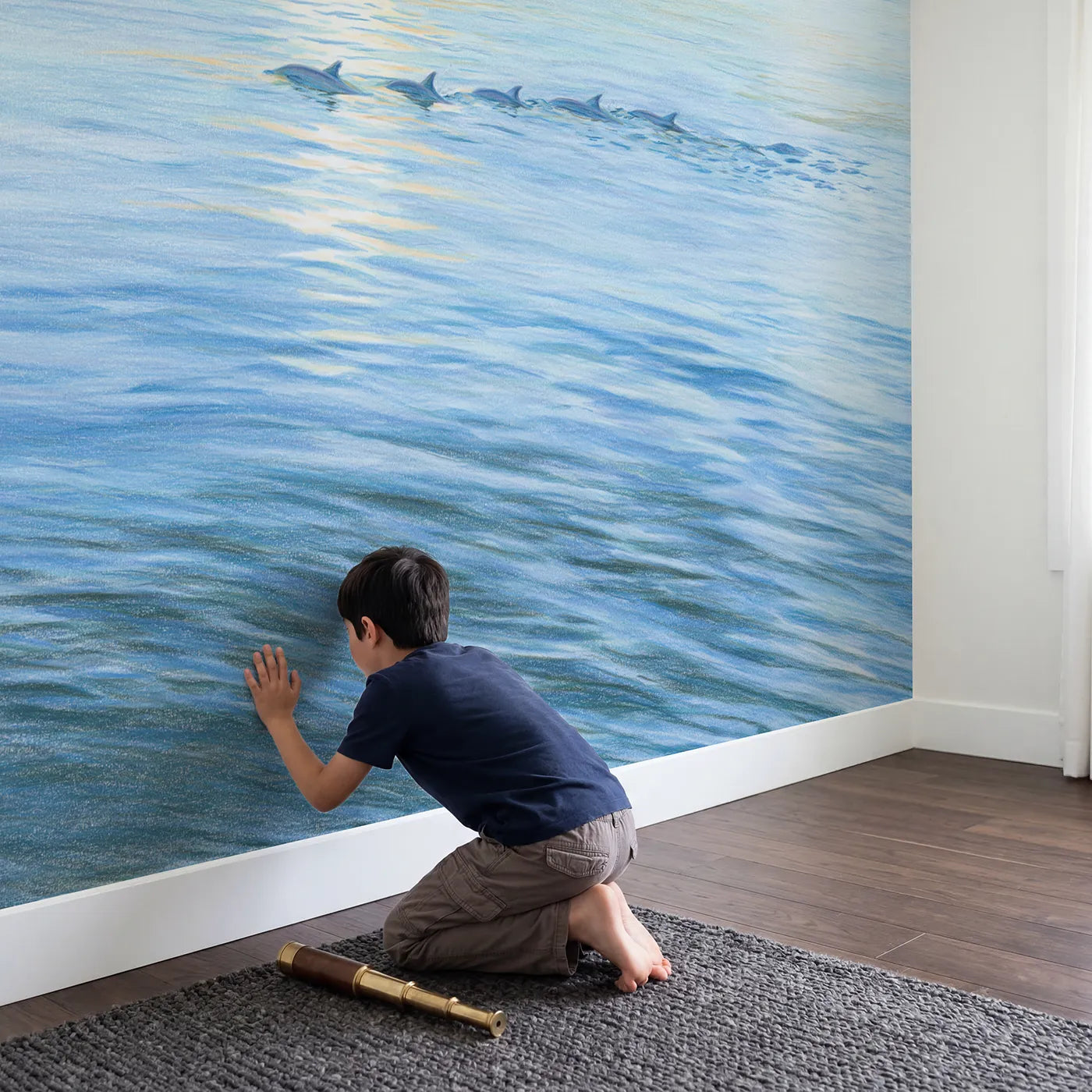 Child in nursery with Dolphins at the Surface Wallpaper Mural by Whimsy Tots