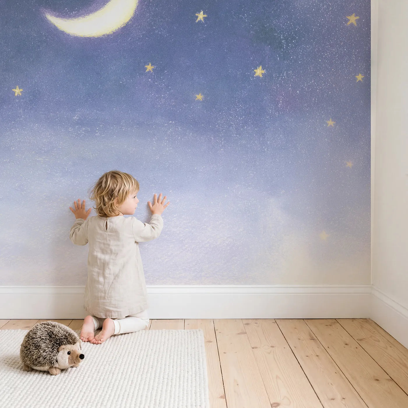Child in nursery with Pastel Moon Stars Wallpaper Mural by Whimsy Tots