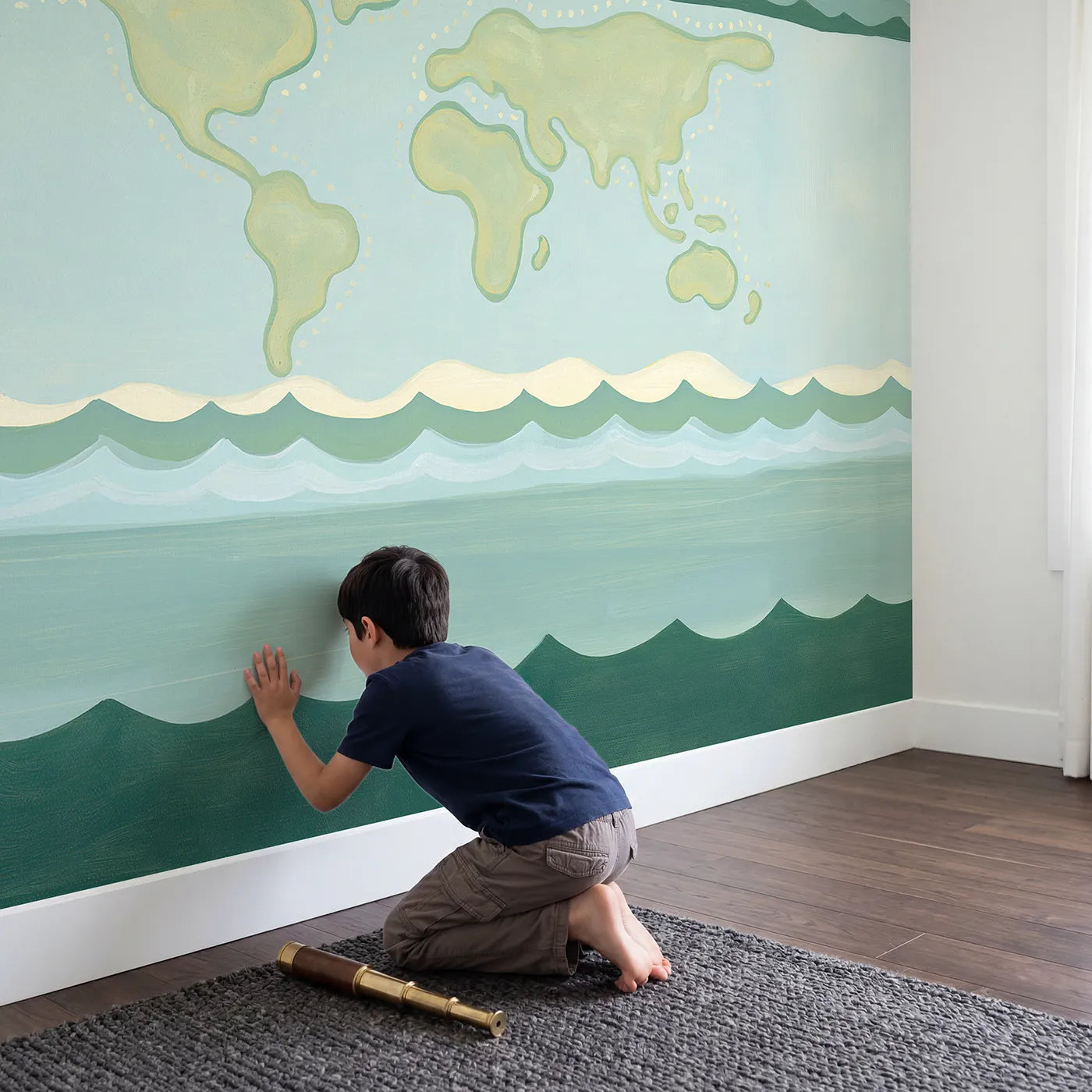 Child in nursery with Folk World Map Wallpaper Mural by Whimsy Tots