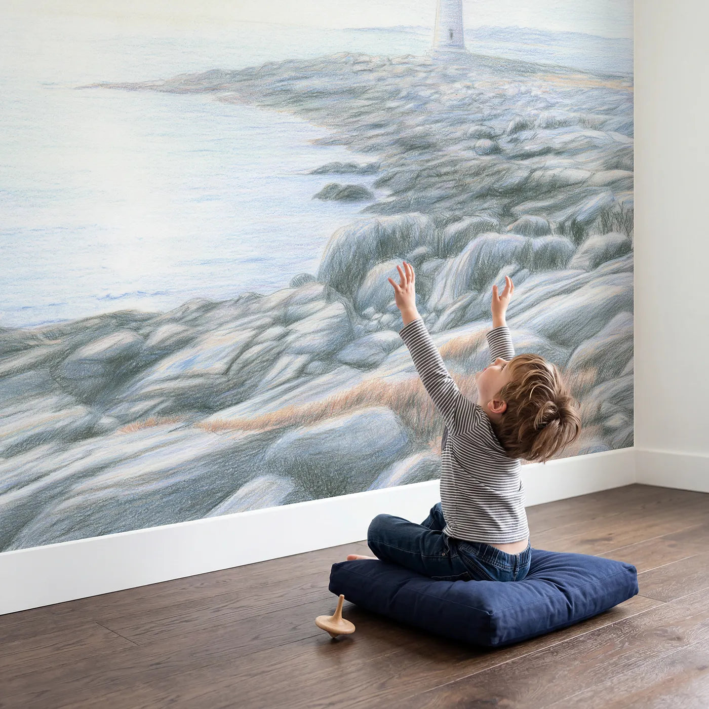 Child in nursery with Gentle Coastal Lighthouse Wallpaper Mural by Whimsy Tots