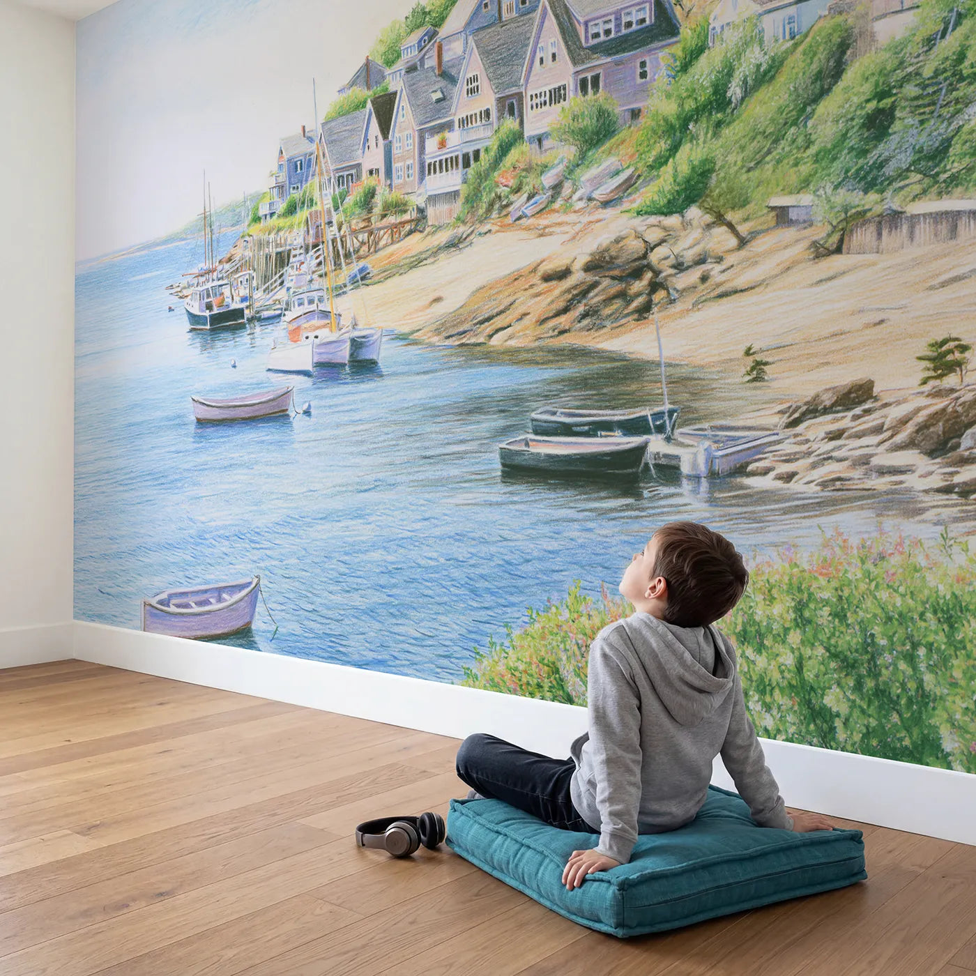Child in nursery with Soft Coastal Village Wallpaper Mural by Whimsy Tots