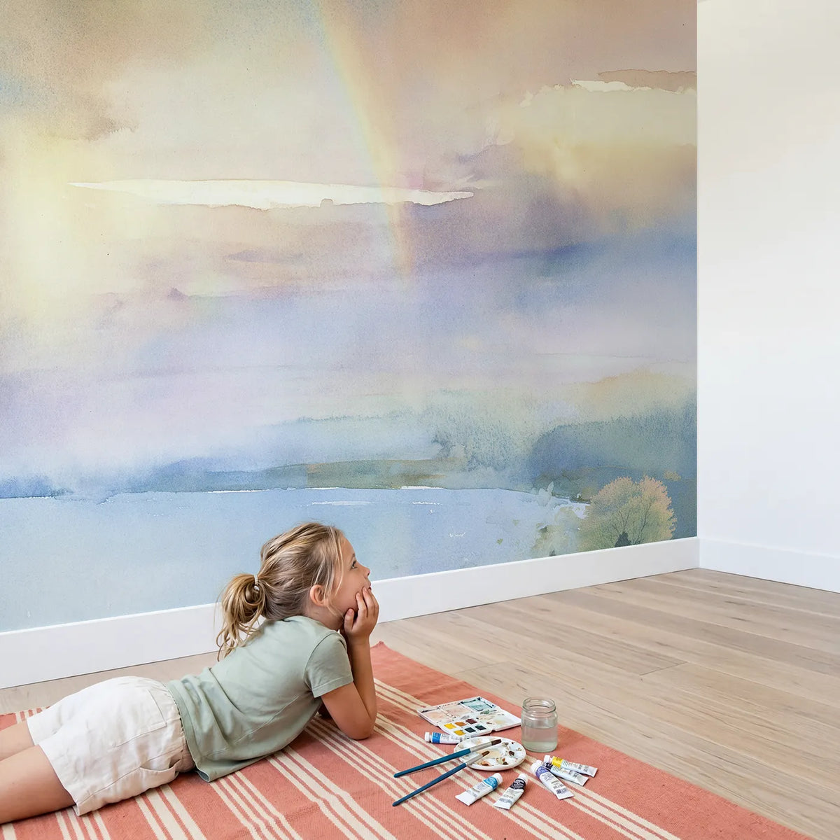 Child in nursery with Misty Rainbow Sky Wallpaper Mural by Whimsy Tots
