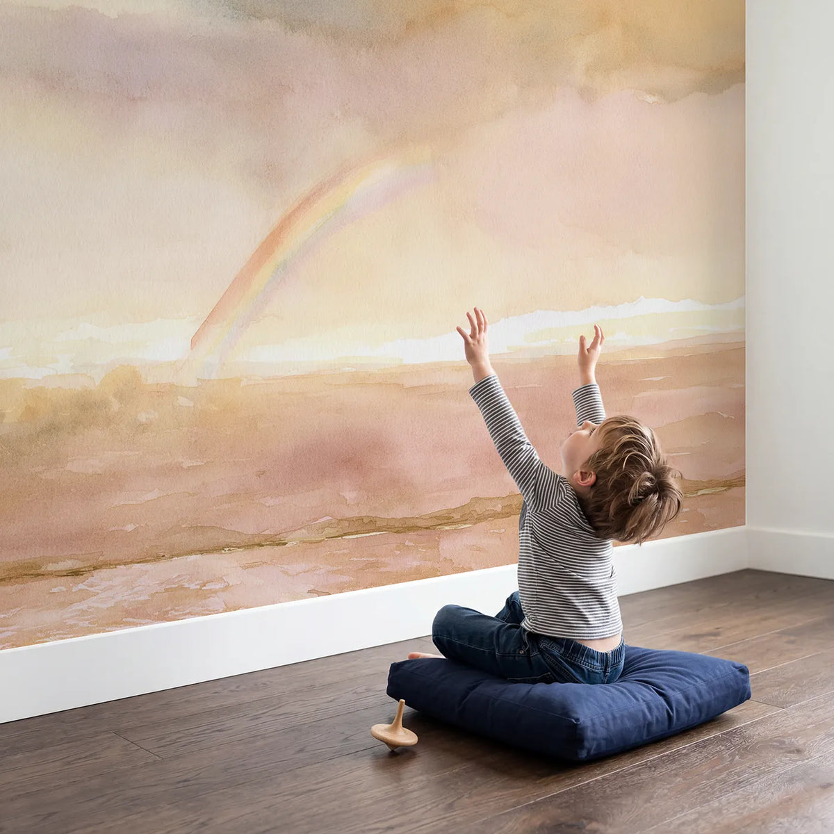 Child in nursery with Soft Sunset Rainbow Wallpaper Mural by Whimsy Tots